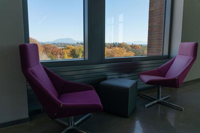 two red armchairs and a table next to windows that look out to Marys Peak